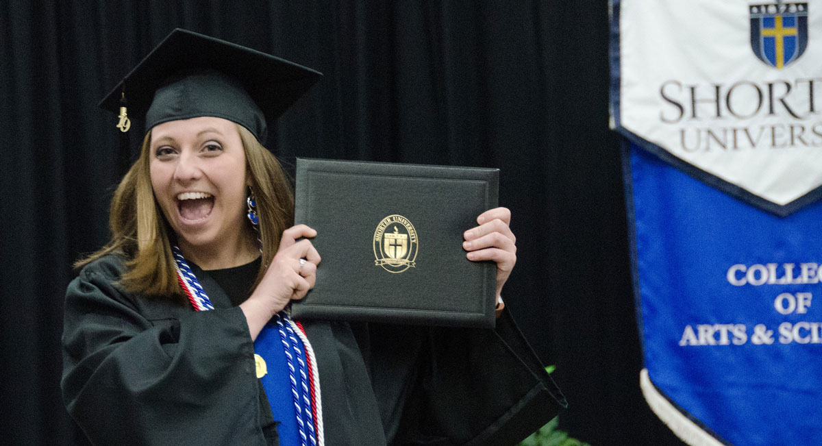 Graduate Rachael Minard celebrates after receiving her diploma.