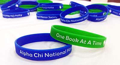 Green and blue bracelets which say One Book at a Time on them.