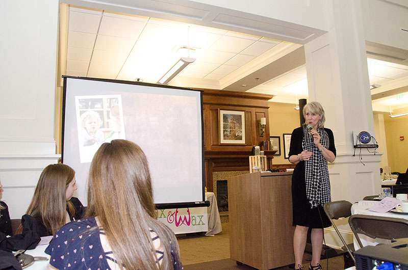 Connie Carey speaking at the Little Black Dress Tea