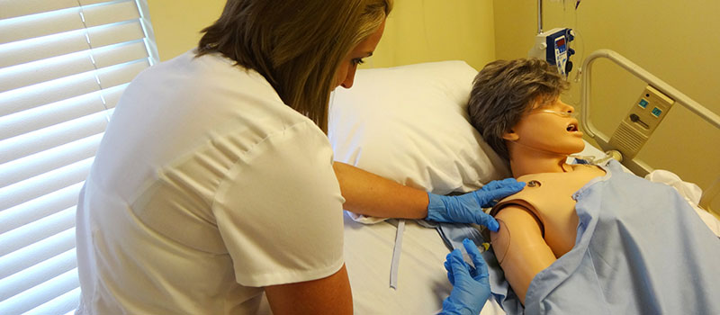 Nursing student practicing injections in simulation lab