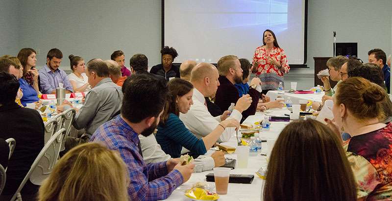 Associate Professor of Biology Lisa Keith, who chairs the Center for Excellence in Teaching Committee, introduces the students taking part in a panel discussion on How Today’s Students Learn in the Digital World.