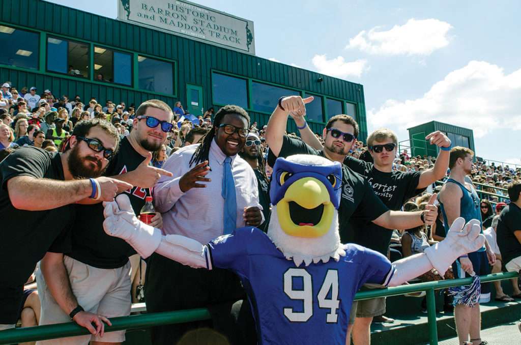 Fans and Hawk mascot at a football game